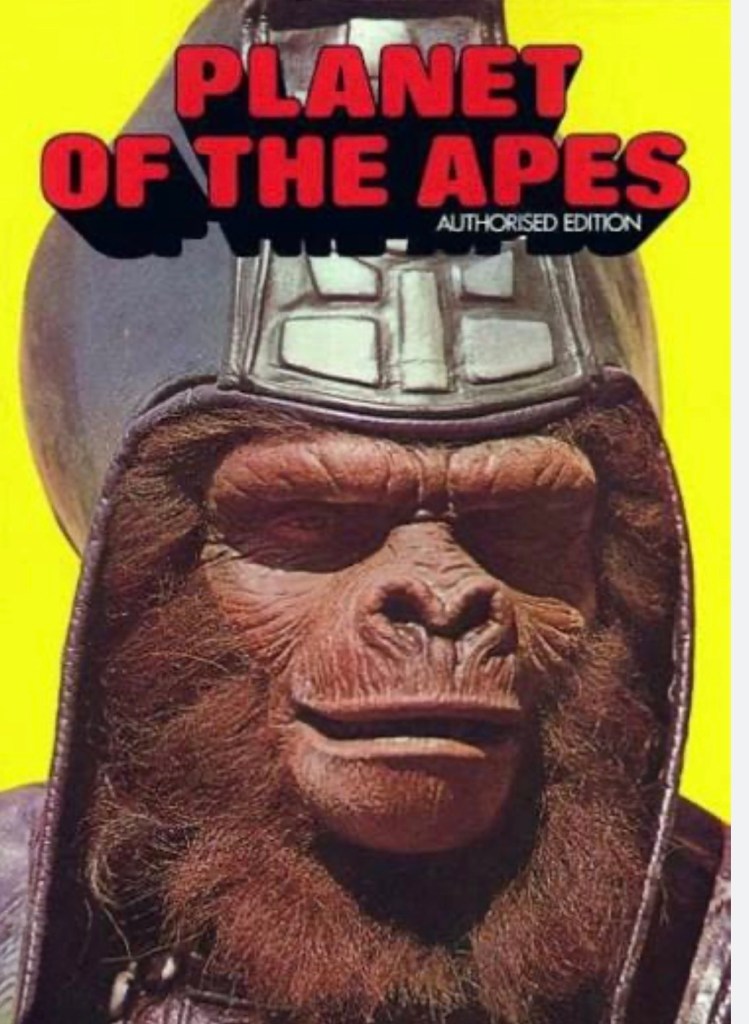 Cover of 'Planet of the Apes' featuring a close-up of an ape character wearing a helmet and a military-style uniform against a yellow background.
