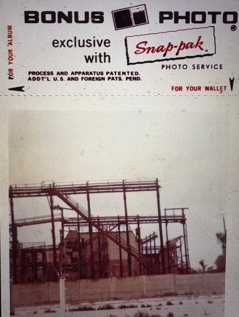 A vintage photo service advertisement featuring the words 'BONUS PHOTO exclusive with Snap-pak' and an image of a partially constructed industrial building with steel framing.
