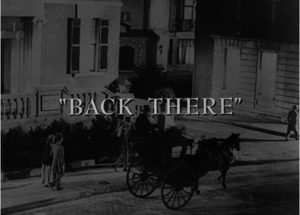 A vintage black-and-white scene featuring a horse-drawn carriage on a street with buildings and people in early 20th-century attire, overlaid with the title 'BACK THERE'.