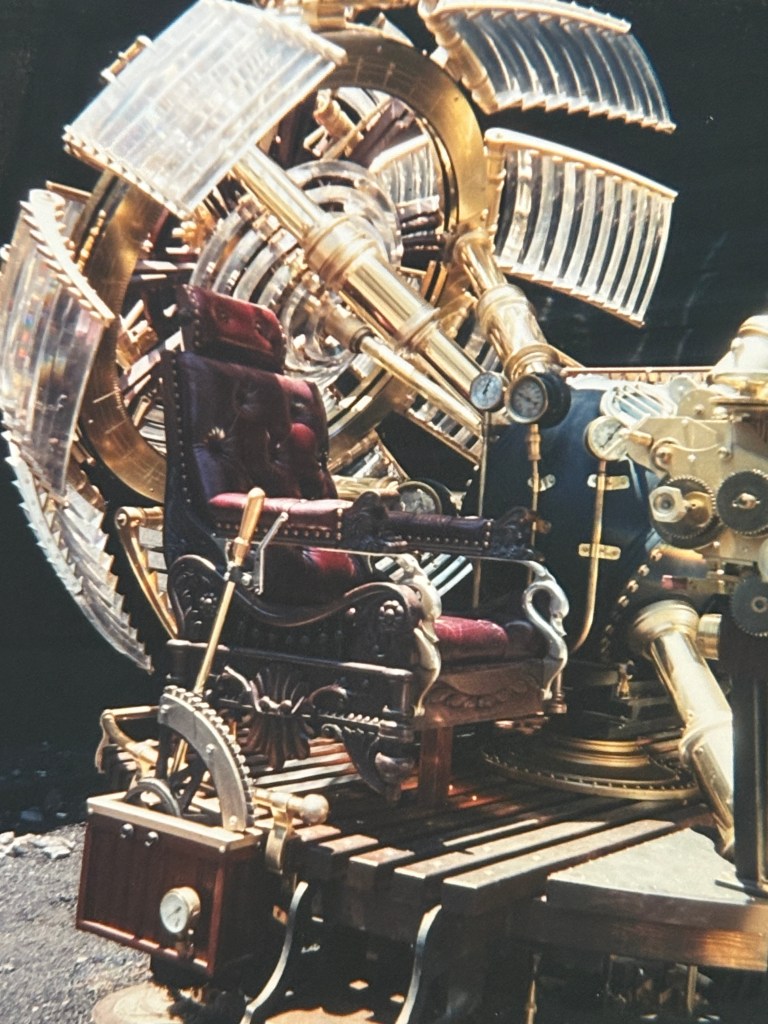 A detailed steampunk-inspired time machine featuring a luxurious chair, intricate brass and glass components, and mechanical gears.