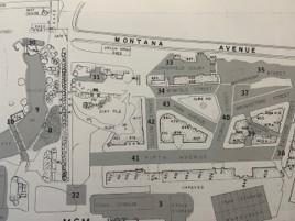 Map showing layout of a residential or commercial area with labeled streets, buildings, and parking spaces.