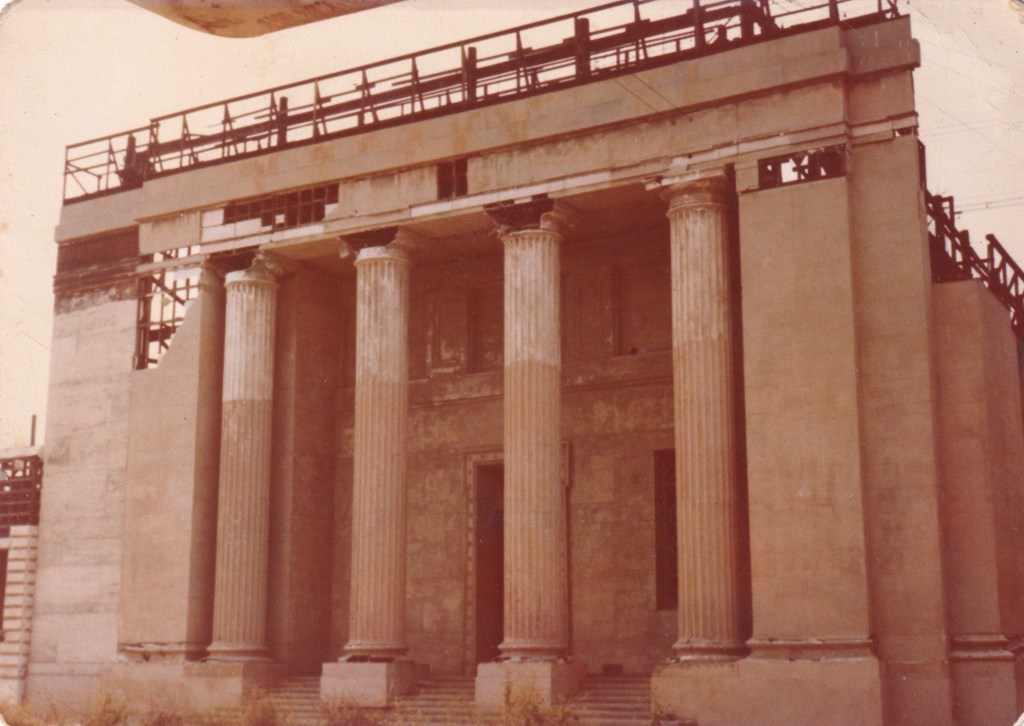 A partially constructed building featuring classical columns and scaffolding on top.