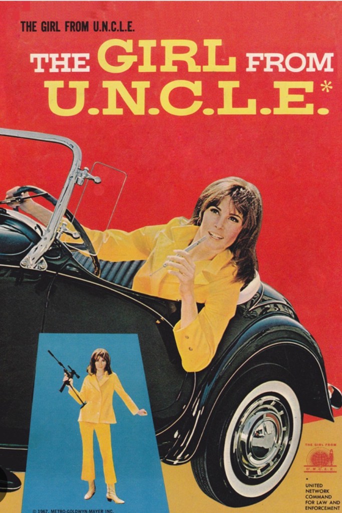A retro poster for 'The Girl from U.N.C.L.E.' featuring a woman in a bright yellow outfit holding a firearm while leaning against a vintage car, with a vibrant red background.